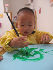 保育園児が絵の具でお絵描きをする様子