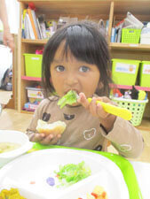 保育園の食育の時間にキャベツを美味しそうに食べる園児の様子