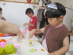 卒園した子供達が保育園の夏祭りで遊んでいる様子